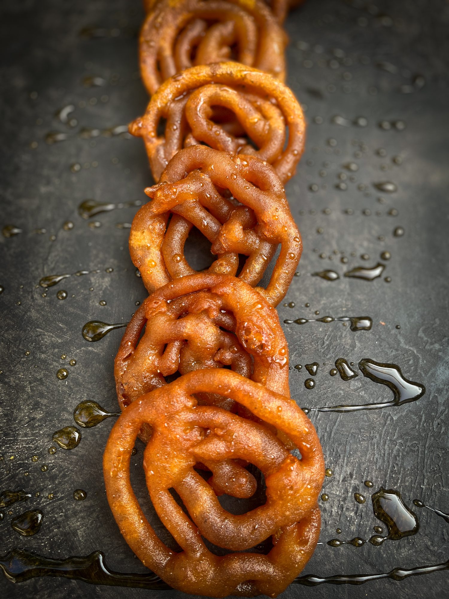 Freshly fried kokis drizzled with treacle